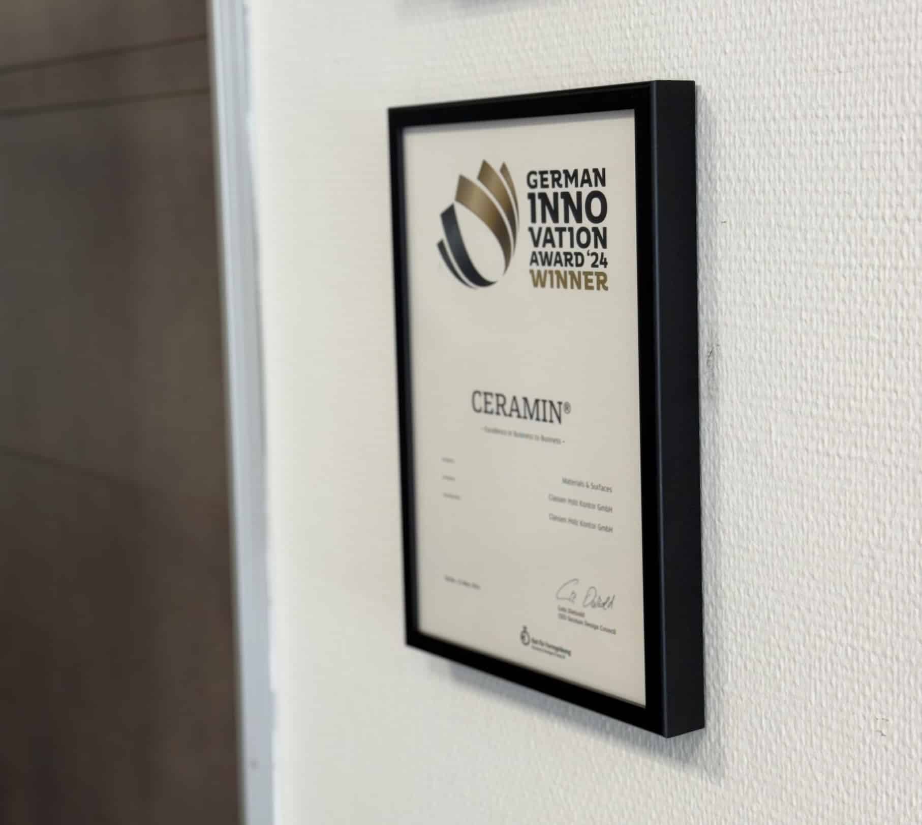 Ein gerahmtes Zertifikat hängt an einer weißen Wand