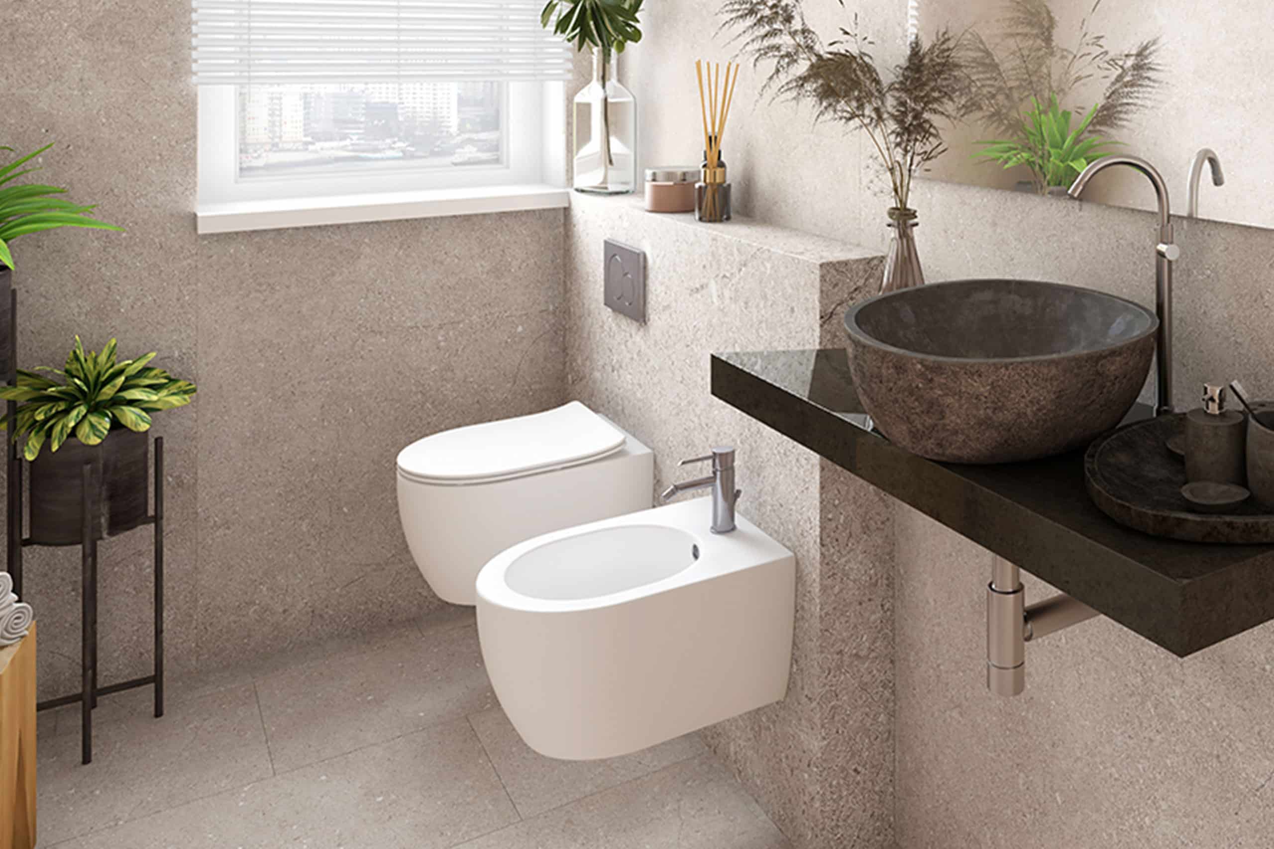 Badezimmer mit wandhängendem WC, Bidet und Aufsatzwaschbecken in Steinoptik – pflegeleicht, platzsparend und in zeitloser Eleganz gestaltet.